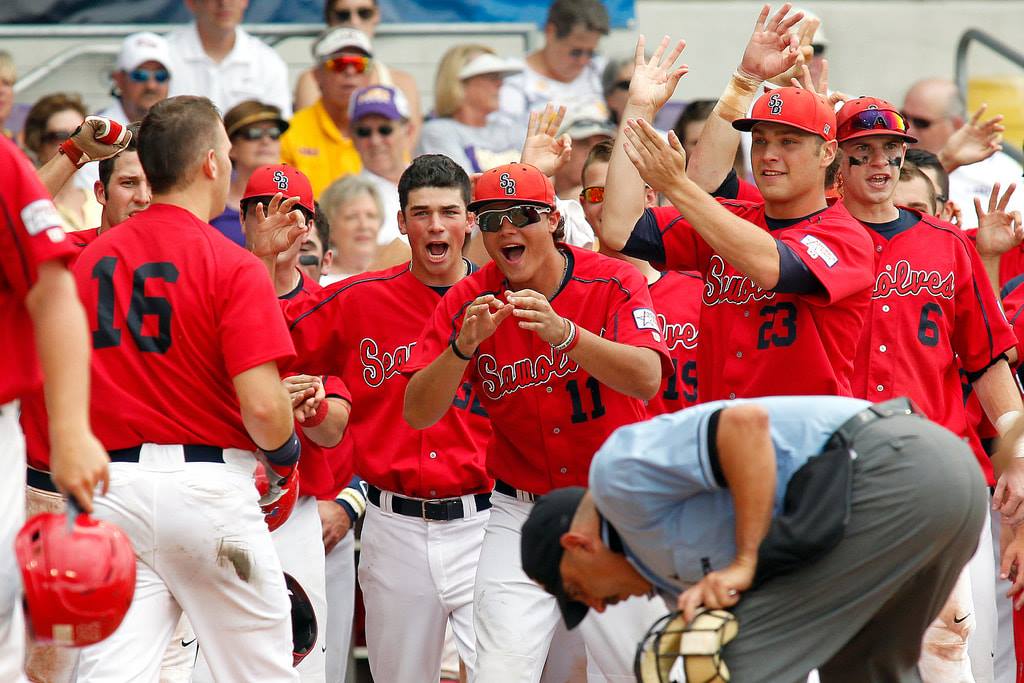 Teammates mob a hitter at home plate after a Super Regional home run